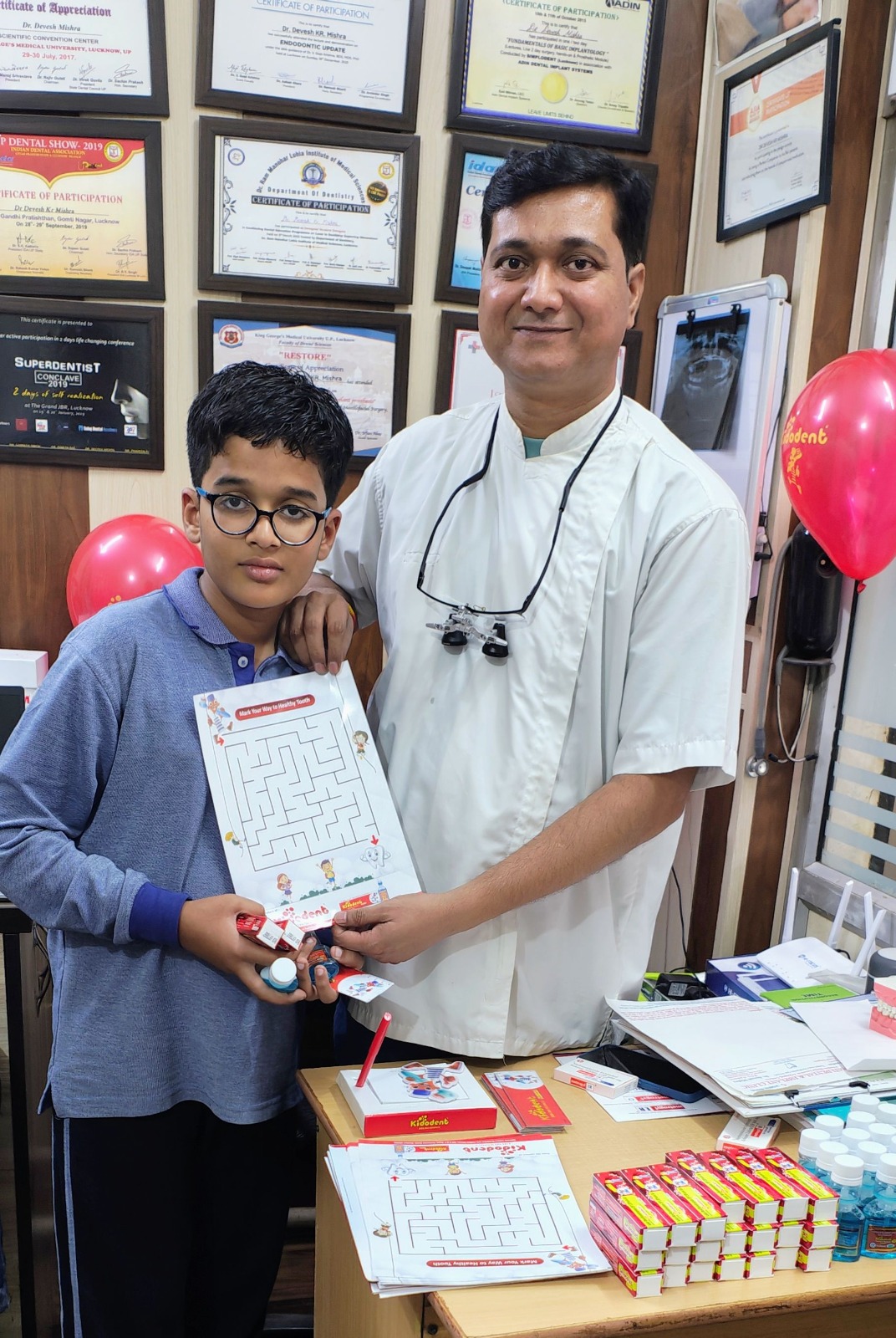 Dr. Devesh Mishra with young patient at dental camp