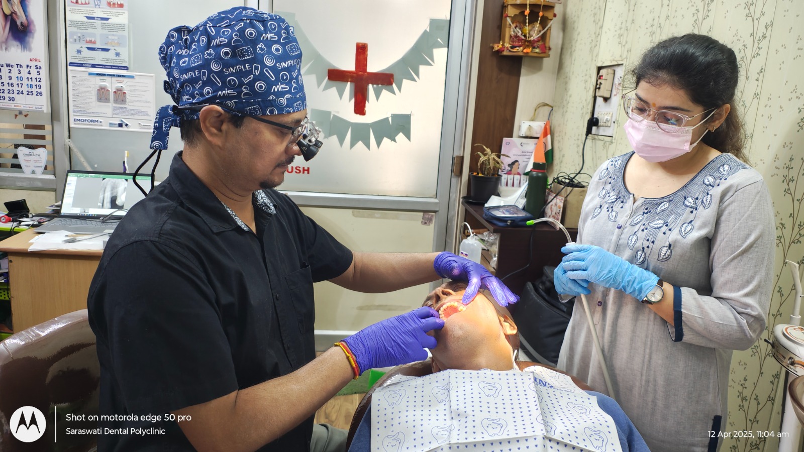 Dr. Devesh Mishra treating patient with dental assistant